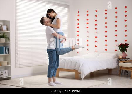 Lovely couple spending time together at home. Valentine`s day celebration Stock Photo